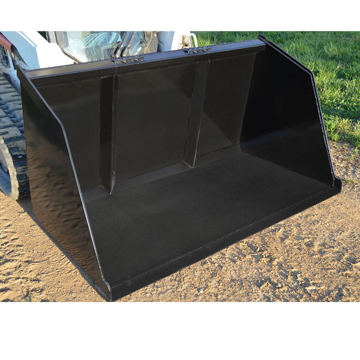 Large black loflin fabrication turkey litter bucket attachment on a dirt surface with grass in the background