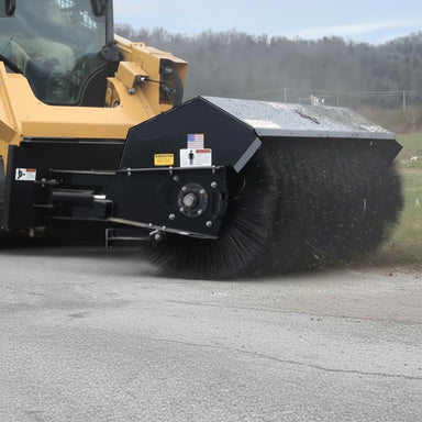 Black Loflin Hydraulic Angle Broom to a vehicle on a road with trees in the background