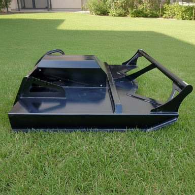 black loflin fabtech skid steer brush cutter on a grassy field with a house in the background side view