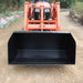 Orange tractor with a black loflin fabricationn trash bucket on a dirt road