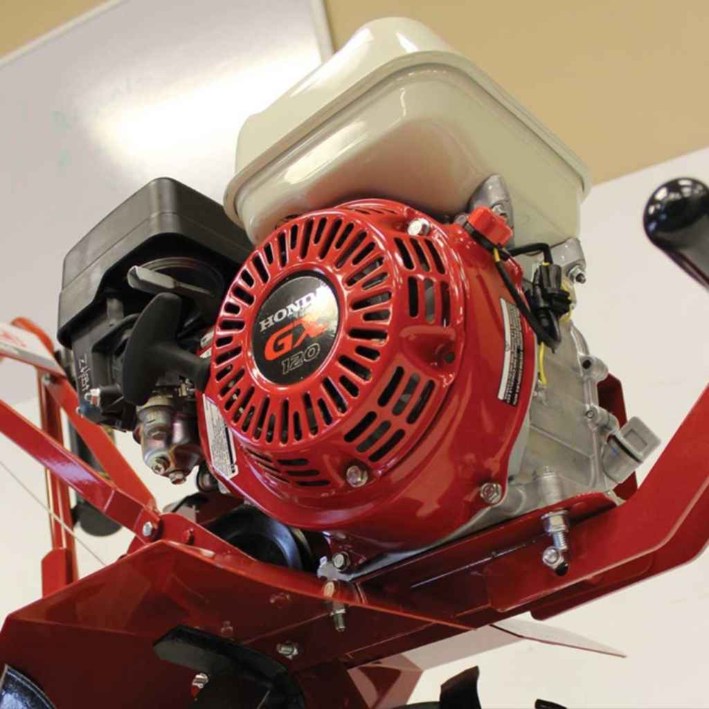 Red maxim tiller rm4h with a Honda engine on a piece of machinery with a white background