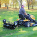 Man operating a riding lawn mower with a black maxim plug aerator 36 inch with wheels in a park setting