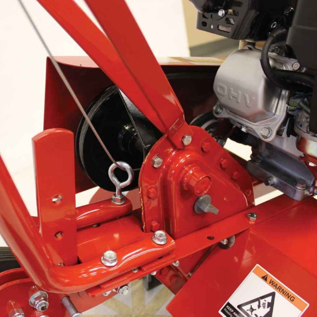 Close-up of a red mechanical component of a  maxim rm4h compact tiller with a visible brand logo on a white background