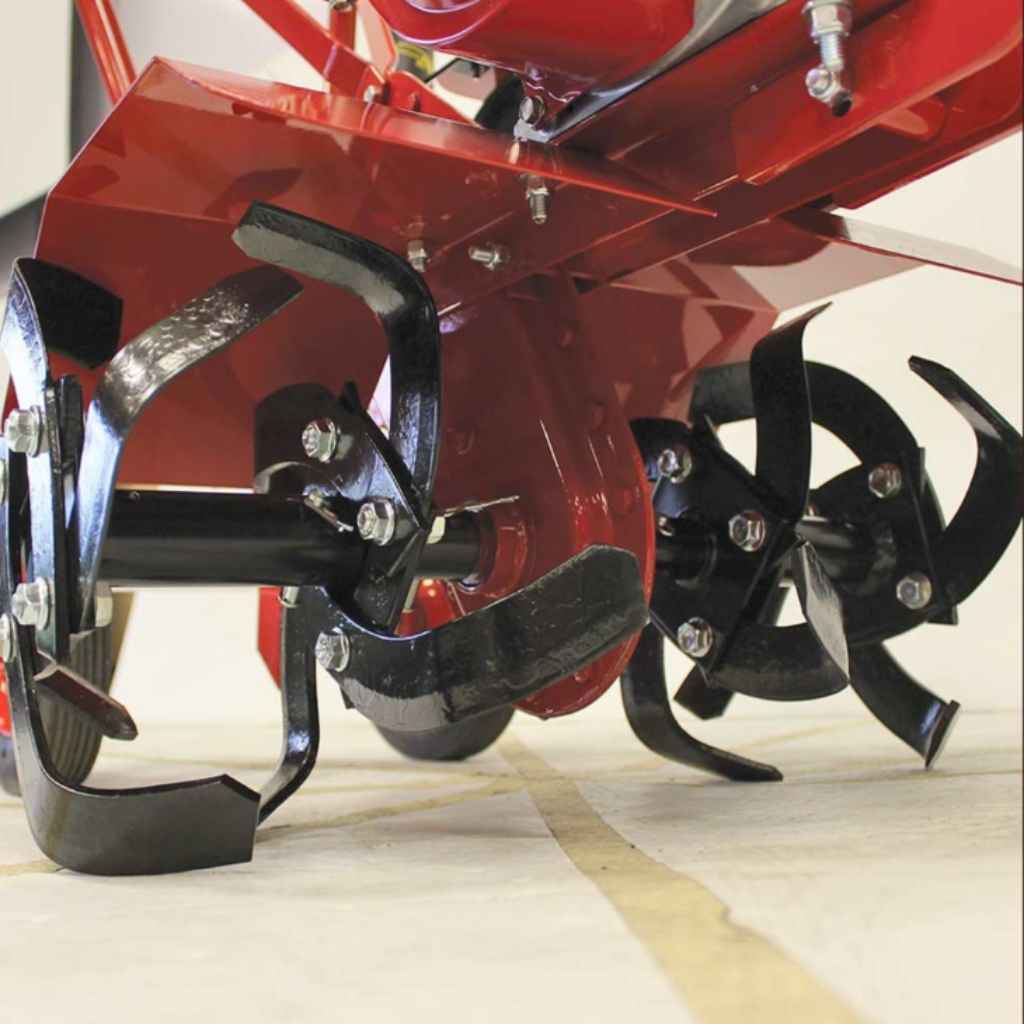 Close-up of a red and black maxim rm4h compact tiller on a light wooden floor.