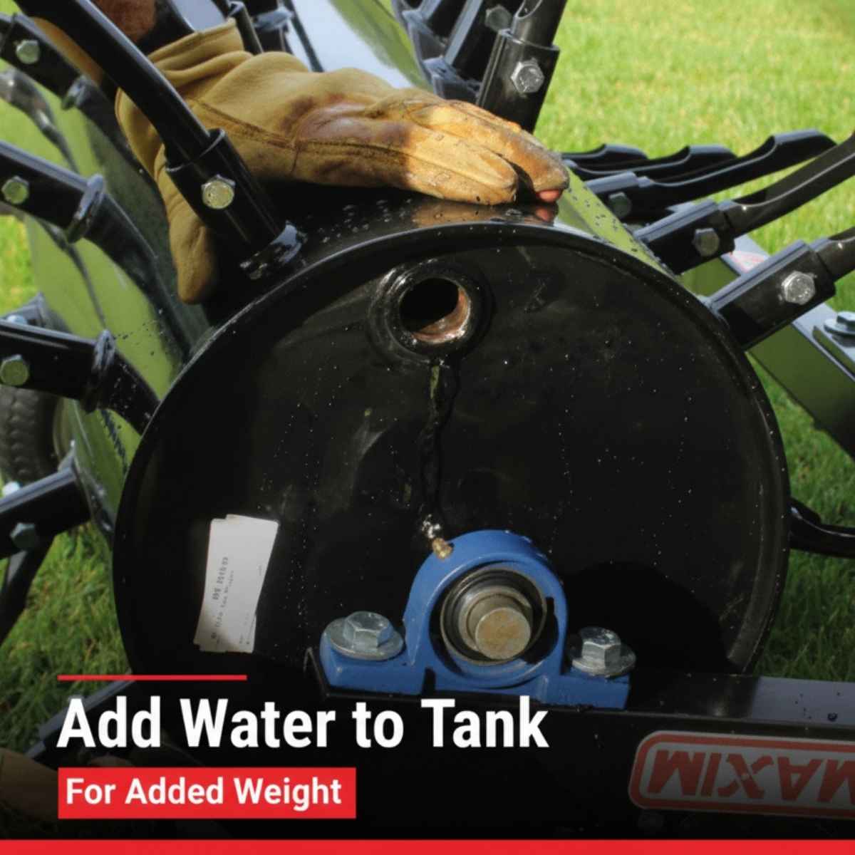 Close-up of a black makinex 48 inch tow behind aerator MSP48 with a gloved hand and text instructing to add water to the tank for added weight.