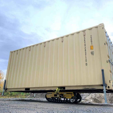 movex xc 30 all terrain carrier carrying a shipping container on a gravel ground