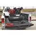 Truck bed with a NorthStar 30 gallon air compressor and hose, outdoors.