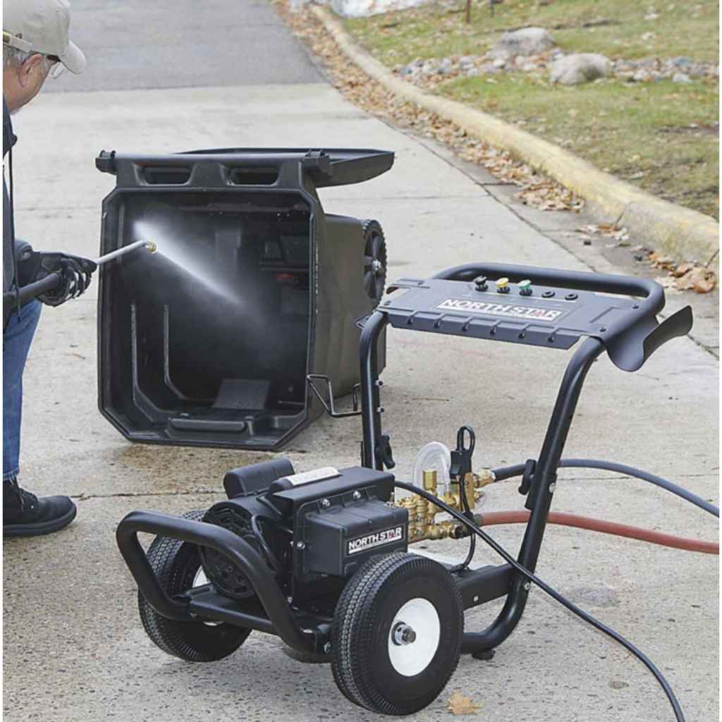 Person using a northstar 2000 psi pressure washer on a driveway