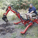 Person operating a red nortrac 15 hp tow behind backhoe trencher in an outdoor setting