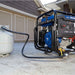 Portable powerhorse 12500 watt generator on a concrete surface with a house in the background