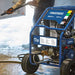Powerhorse 3600 psi hot water pressure washer with 'Powerhorse' branding being used on a concrete surface.