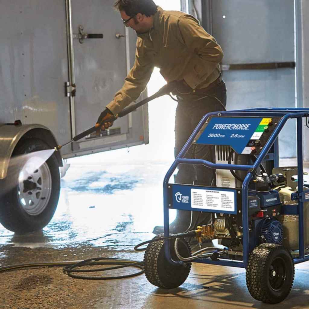 Person using a powerhorse 3600 psi  hot water pressure washer 2.6 gpm in front of a trailer