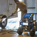 Person using a powerhorse 3600 psi  hot water pressure washer 2.6 gpm in front of a trailer