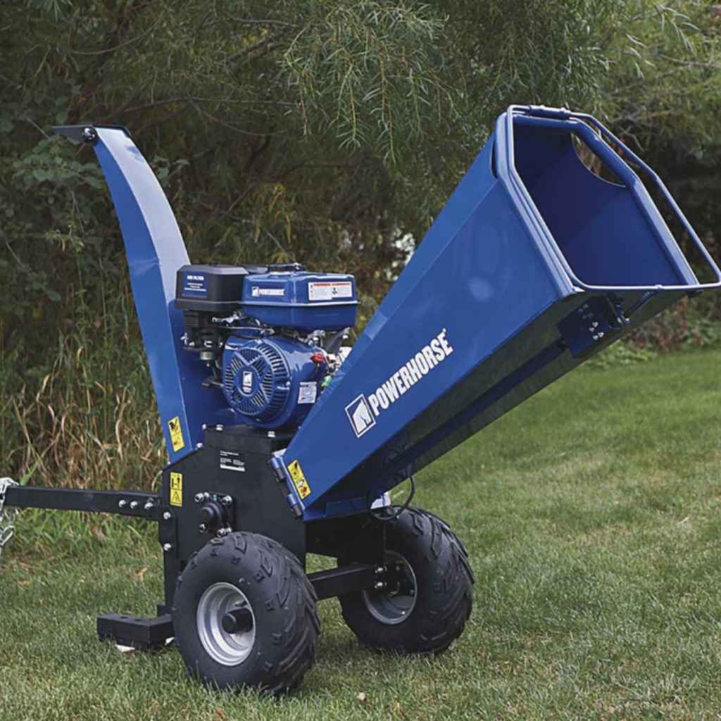 Blue Powerhorse wood chipper 420cc on grass with trees in the background