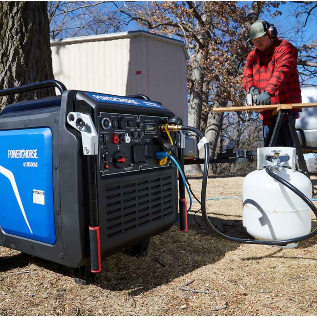 powerhorse 10500 watt inverter generator with a person using a chainsaw in an outdoor setting