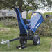 Blue powerhorse 420cc towable wood chipper on a grassy area with trees and a house in the background
