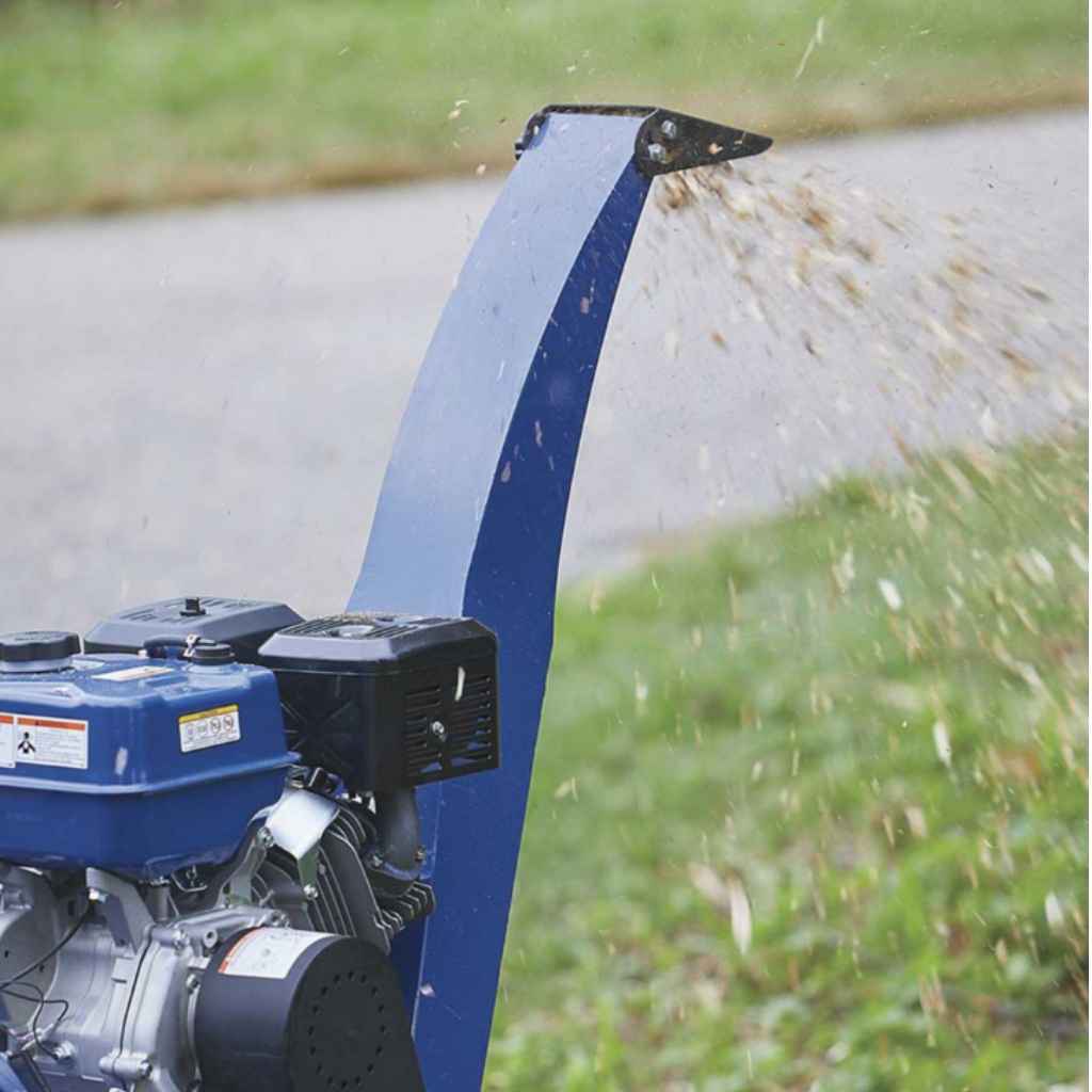 powerhorse 5 in 420cc wood chipper in use on a grassy area with a blurred background