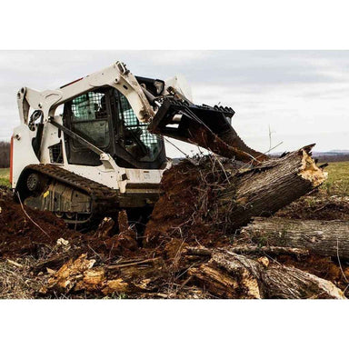 Skid steer loader with a loflin fab stump bucket lifting a large log in an outdoor setting