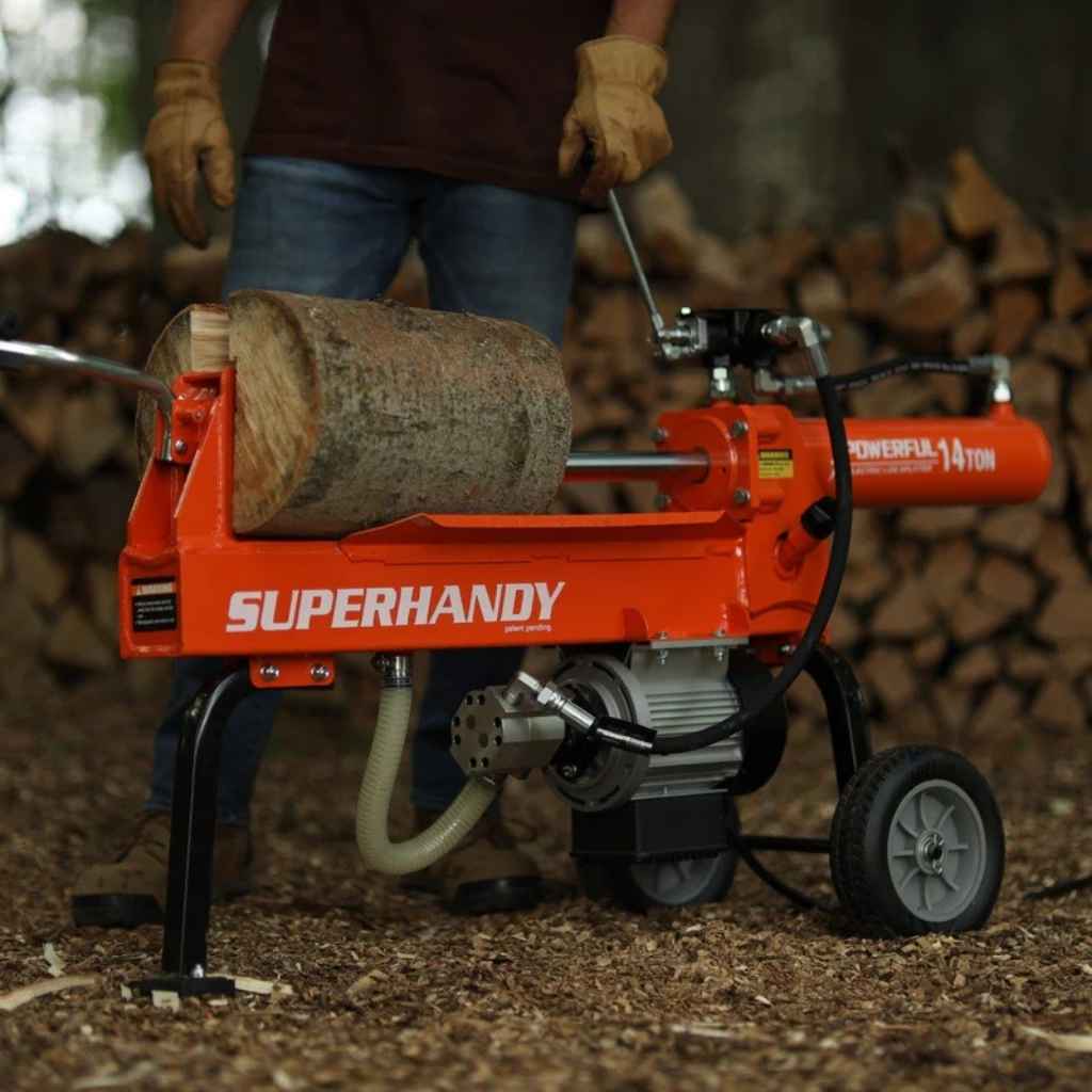 Person operating a SuperHandy electric log splitter 14 ton with a log on it, surrounded by stacked firewood.