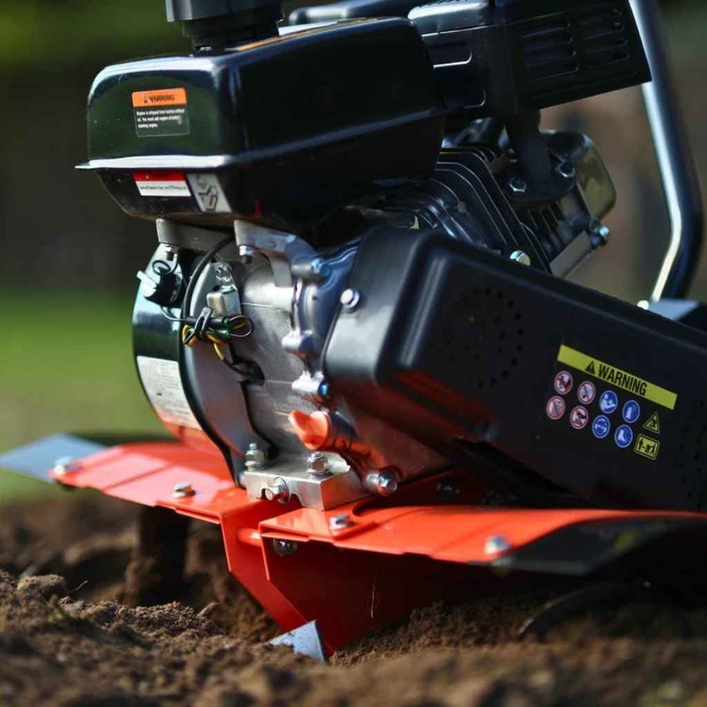 Close-up of a superhandy garden tiller 27 inch engine on a grassy background