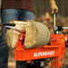 Person using a Superhandy 20 ton gas log splitter with a log in the process.