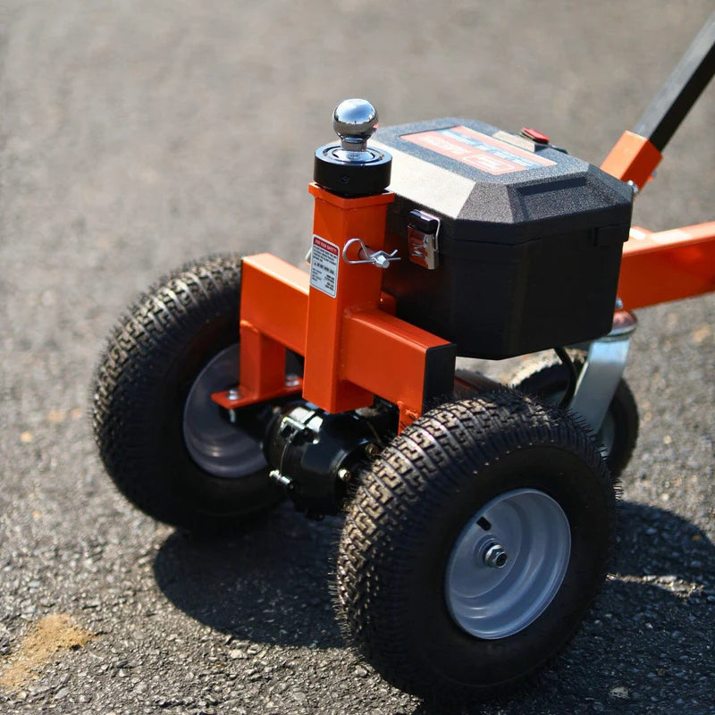An orange and black SuperHandy 2800 lb Electric Trailer Dolly with all-terrain tires, a powerful electric motor, and a height-adjustable hitch. Wheel view outdoors.