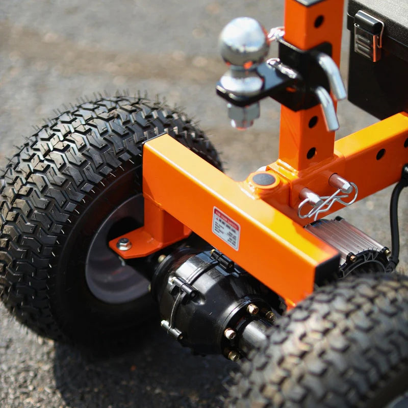 An orange and black superhandy electric trailer dolly 3600 lbs with four wheels and a control panel. Wheel view outdoors.