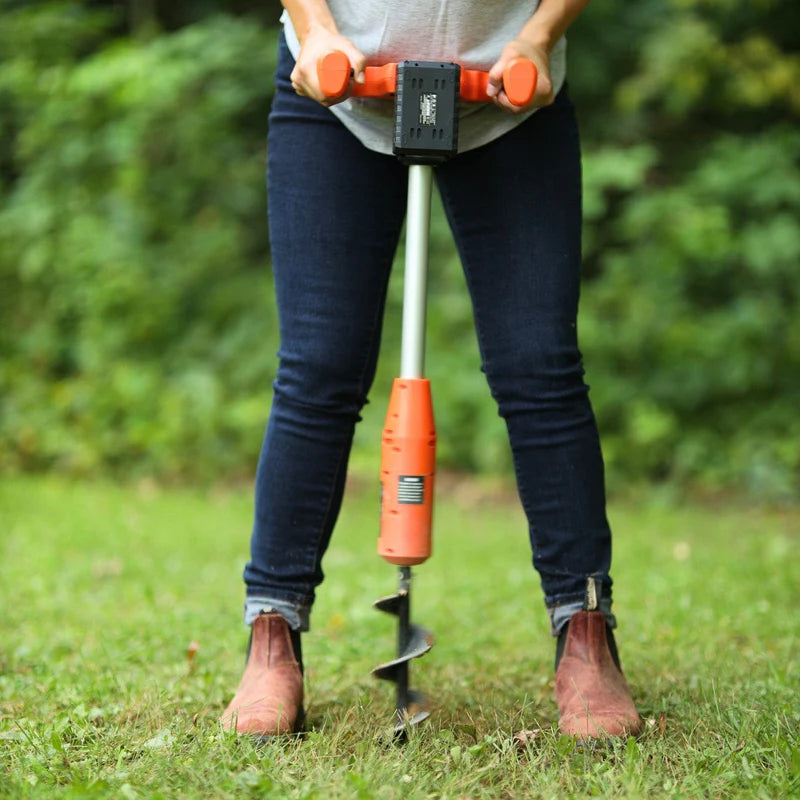 Electric Earth Auger with a 20V 4Ah battery, featuring an orange and black color scheme, with a auger bit inserted vertically. Front view outdoors in use.