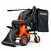 An orange and black gas powered leaf vacuum and wood chipper with a black collection bag and wheels for mobility.