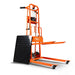 An orange material lift stacker and pallet dolly with a hand crank and swivel caster wheels. Side view.