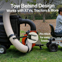 Tow behind design for ATVs and tractors with a person sitting on a trailer.
