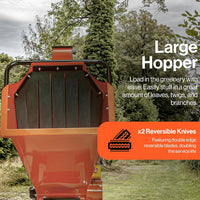 Orange garden shredder with text highlighting features like a large hopper and reversible knives, set against a natural background.
