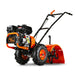 A rear tine tiller with orange, black, and gray coloring, featuring a gas engine and large wheels for garden soil preparation. Back side view.