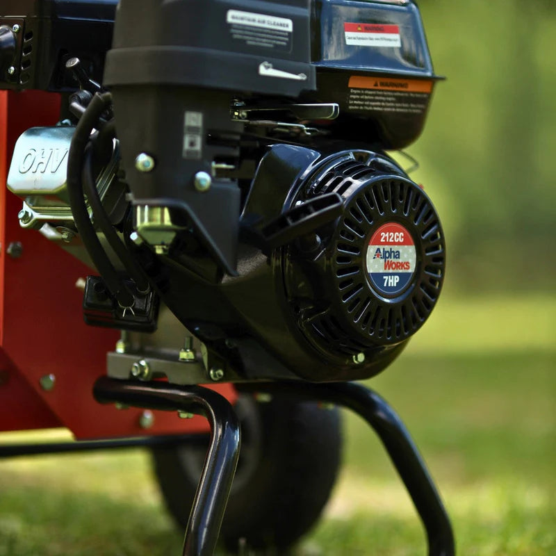An orange mini wood chipper with a 7HP gas powered engine, equipped with wheels for mobility. Engine view outdoors.