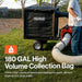 Person using a SuperHandy leaf vacuum 180 gal with a large collection bag on a grassy area.