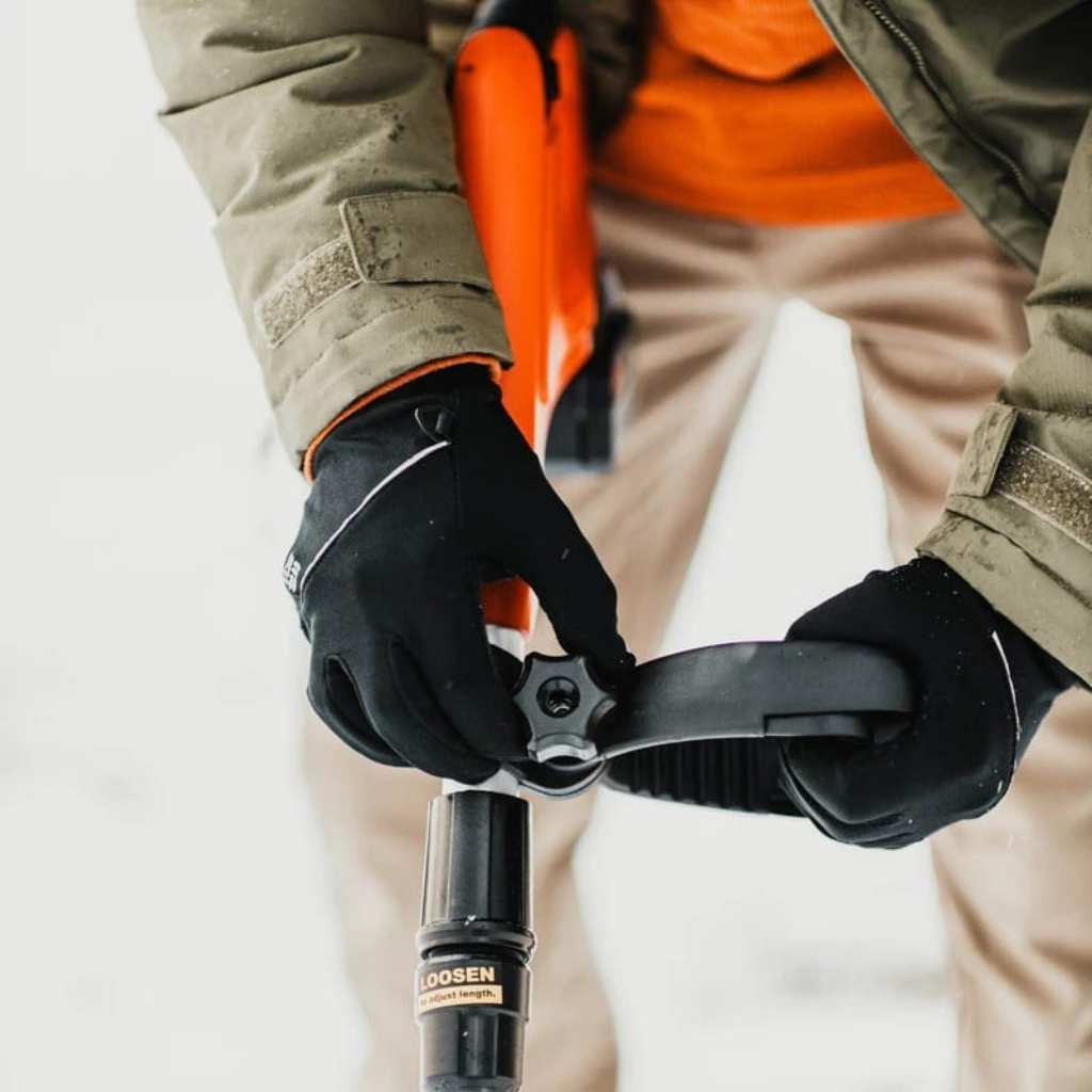Person using a superhandy electric 20v snow blower with a focus on the tool and hands