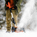 Person using a superhandy 20v snow shovel to clear snow in a winter setting