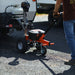 An orange and black SuperHandy 2800 lb Electric Trailer Dolly with all-terrain tires, a powerful electric motor, and a height-adjustable hitch. Handle view outdoors in use.