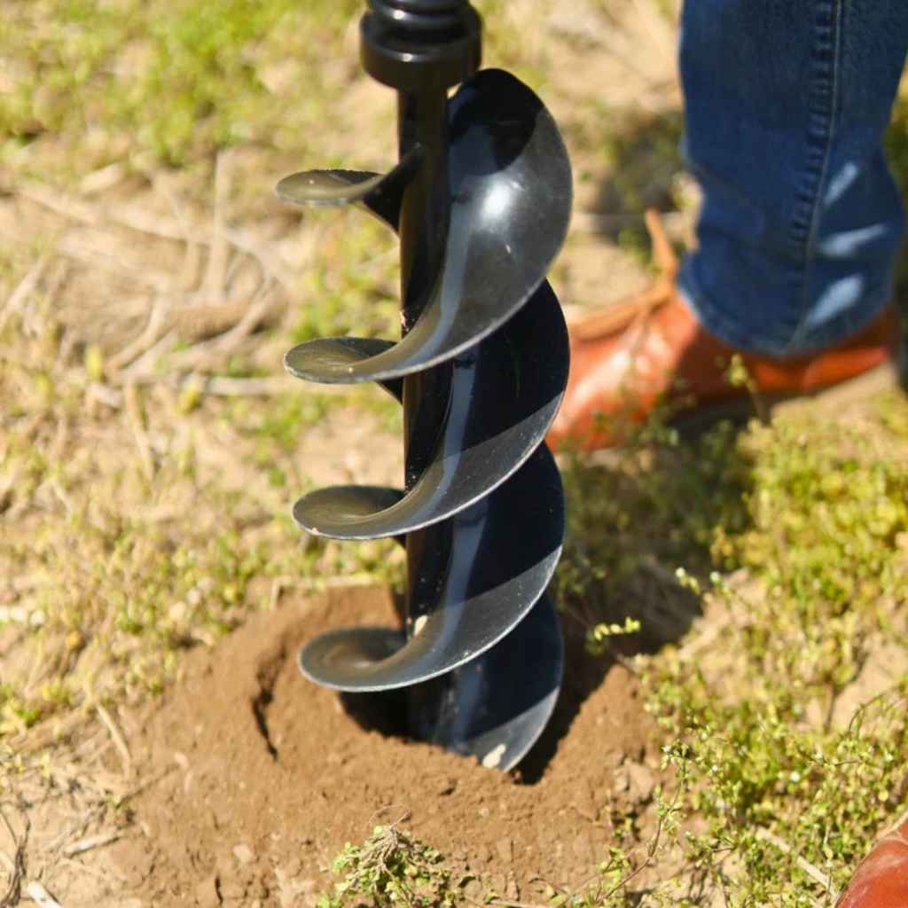 superhandy earth auger 48v in use on a patch of dirt with a person wearing boots in the background.