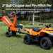 Orange ATV towing a superhandy tow behind 5 in wood chipper with a 2-inch ball coupler and pin-hitch bar in a grassy outdoor setting.