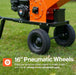 An orange and black Superhandy 5 inch towable Wood chipper shredder with black 16-inch pneumatic wheels on grass with text that says 16" pneumatic wheels 