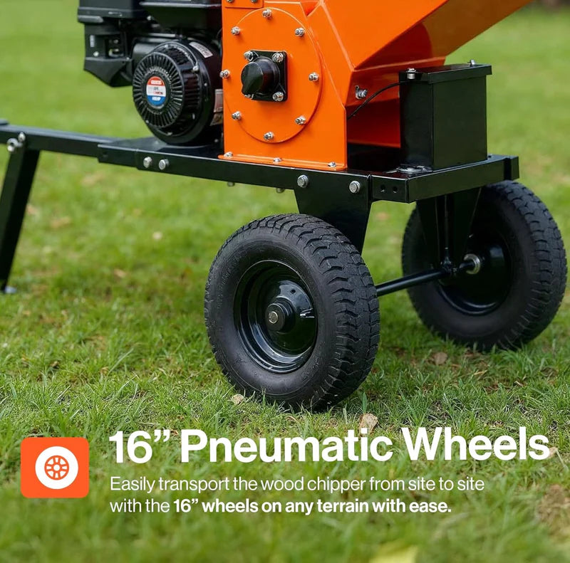 An orange and black Superhandy 5 inch towable Wood chipper shredder with black 16-inch pneumatic wheels on grass with text that says 16" pneumatic wheels 