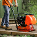 Person operating a superhandy plate compactor 7 hp with water tank
outdoors