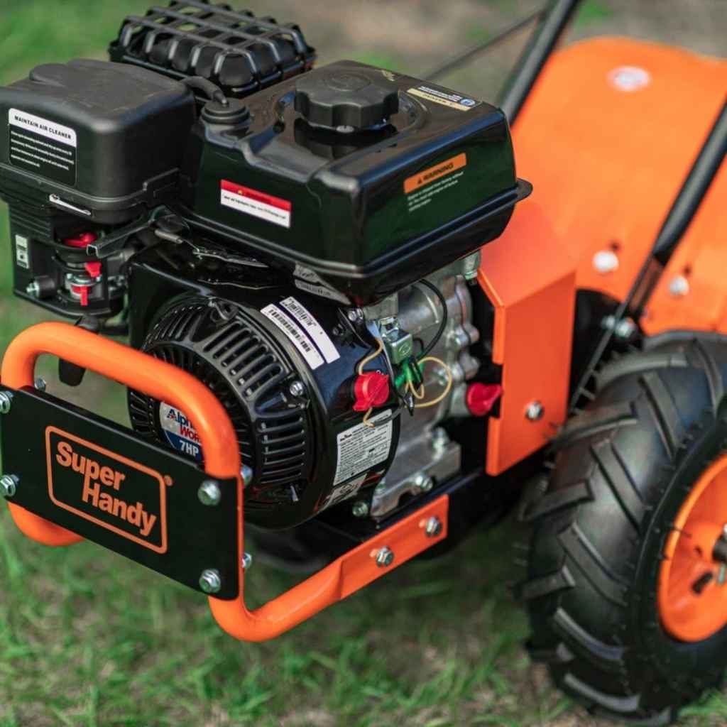 Close-up of a Super Handy rear tine tiller on grass