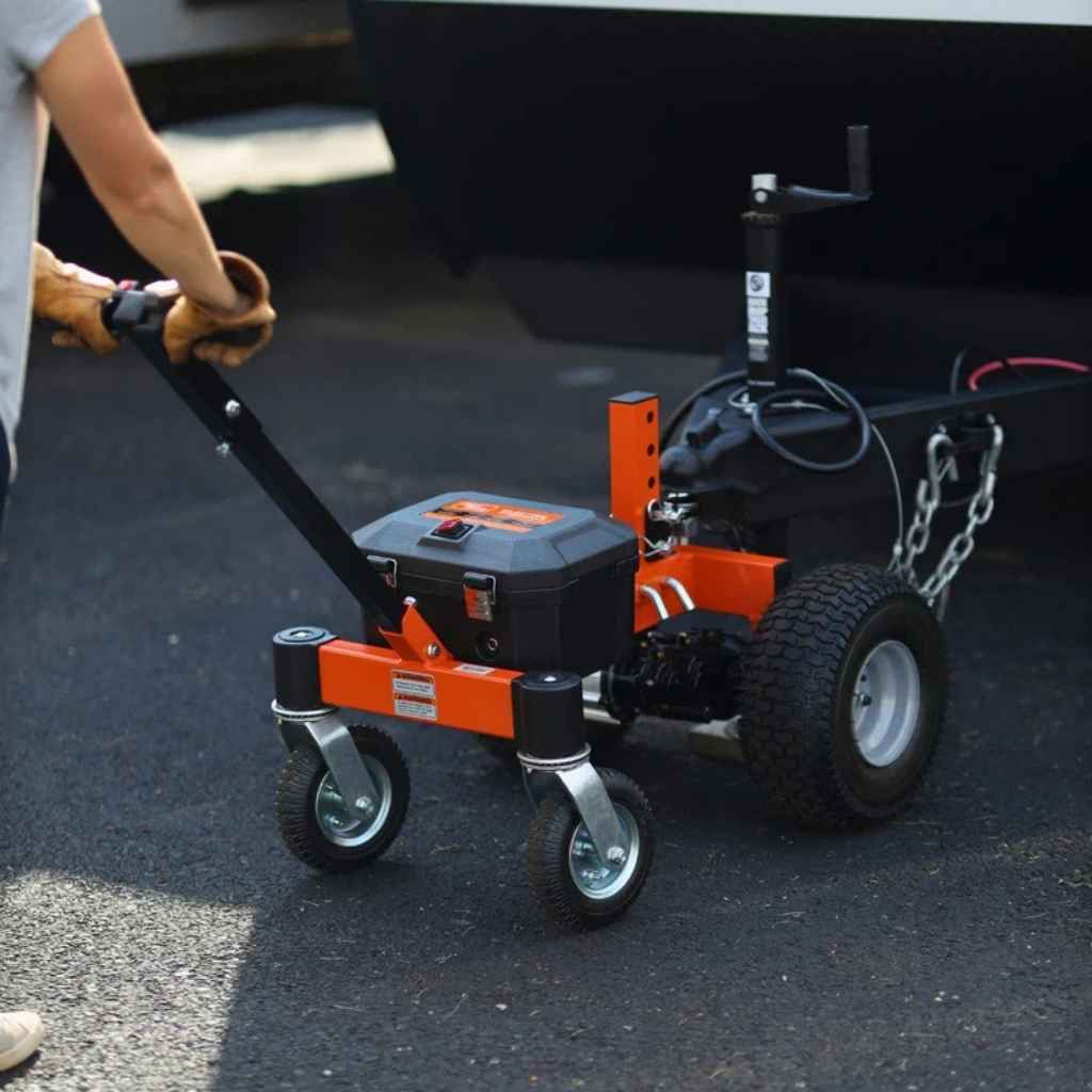 Person using a superhandy 3600 lb trailer dolly to pull a trailer