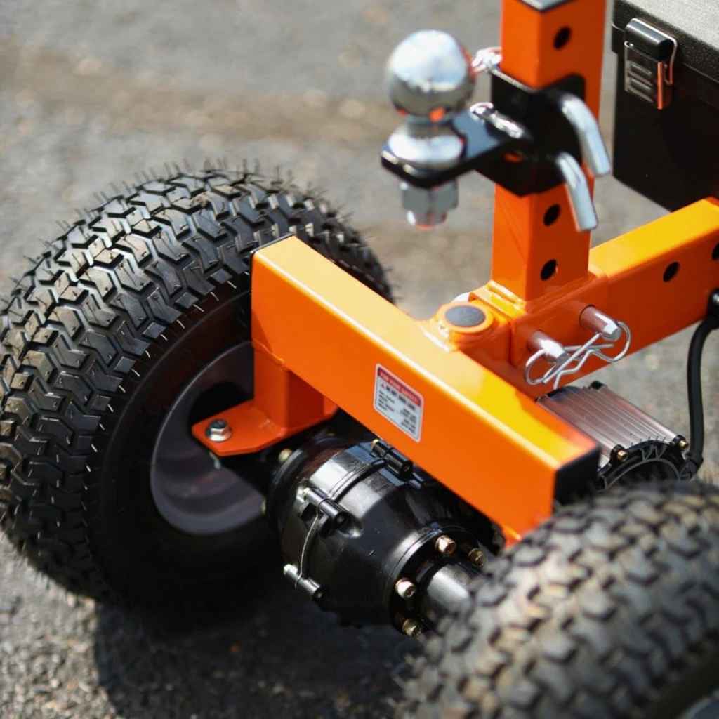 Close-up of an orange superhandy electric trailer dolly 3600 lbs on a road.