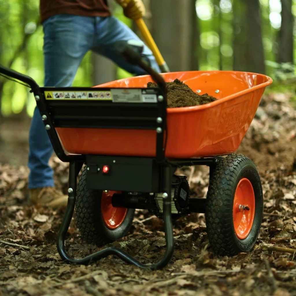 Orange superhandy 24v electric wheelbarrow with soil in a forest setting