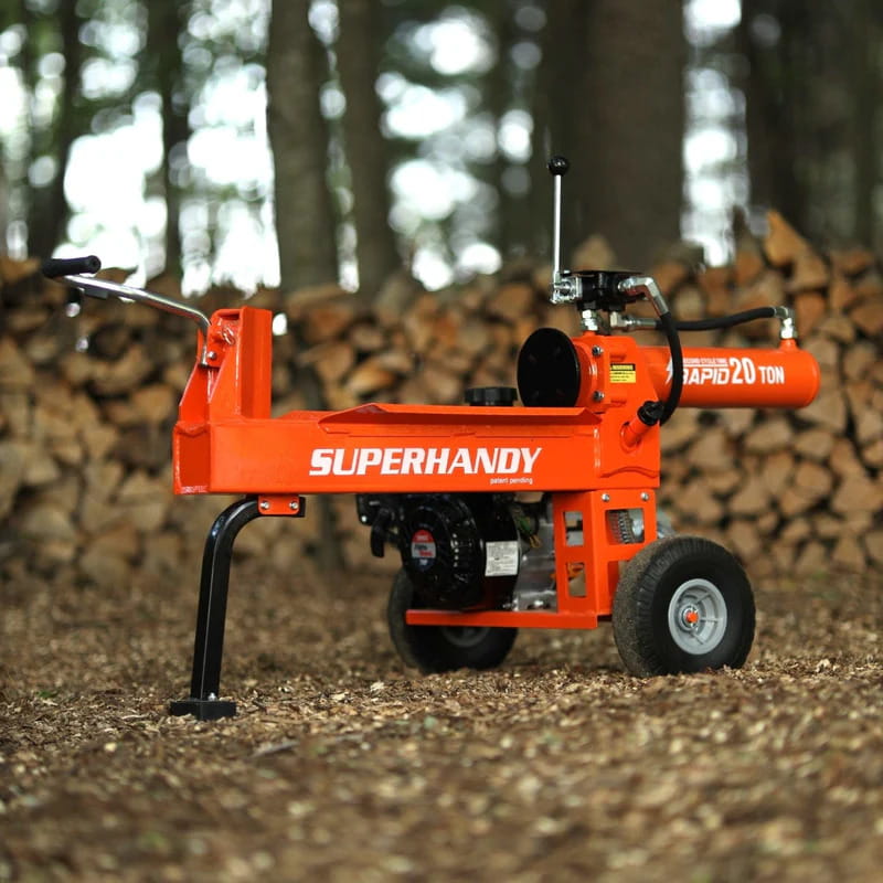 Orange SuperHandy 20 ton gas powered log splitter in a forest setting with stacked logs.