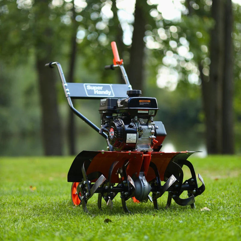 A orange and black superhandy garten tiller 27 inch with orange wheels and a 209CC engine. Front view oudoors